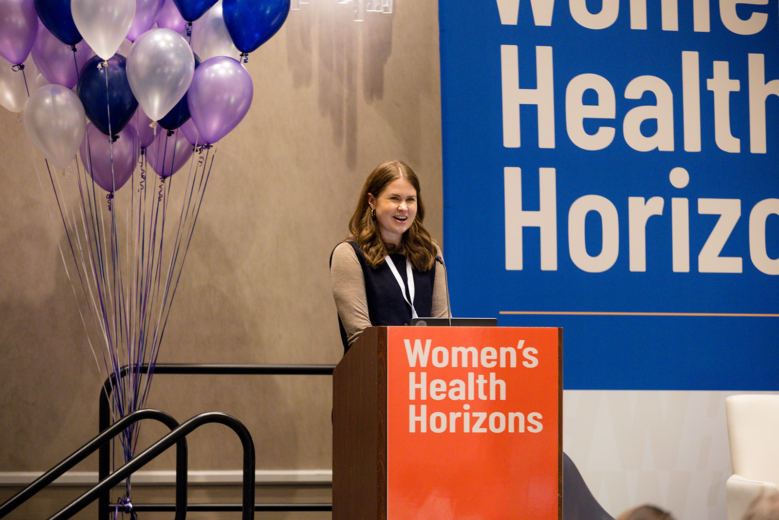 Ashleigh Niziol speaking from the Women's Health Horizons podium